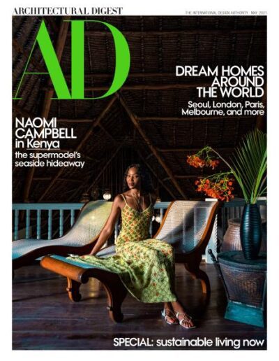Cover of architectural digest featuring a woman posing in an elegantly designed room, highlighting sustainable living and dream homes around the world.