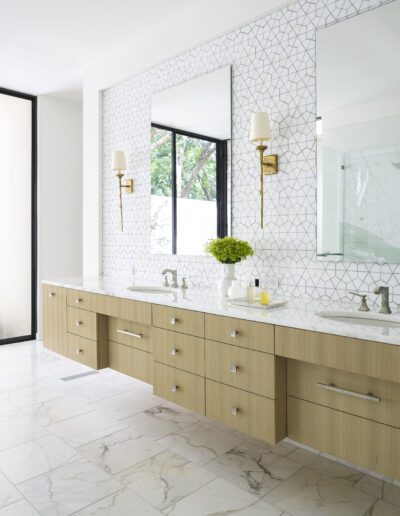 Modern bathroom interior with a double vanity and geometric tiles.