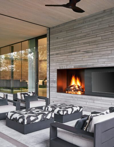 Modern outdoor living space with a fireplace and comfortable seating.